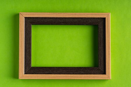 Empty photo frame against green background with Copy space for textの写真素材