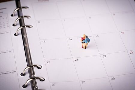 Love concept. Miniature couple against pink backgroundの写真素材