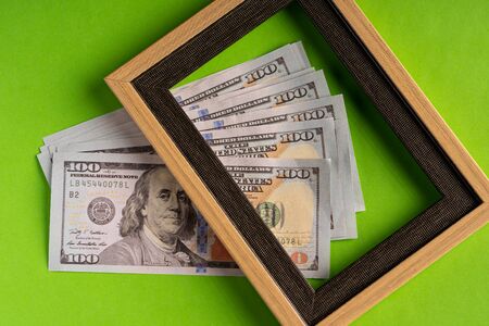 US Dollar bills against green background