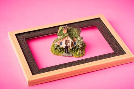 Love concept. Miniature couple against pink background