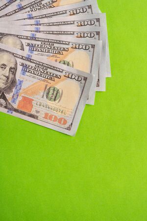 US Dollar bills against green background