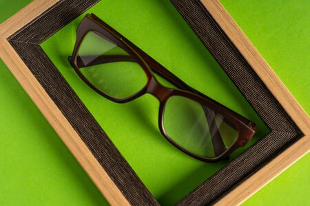 Spectacle or eye glass isolated against green