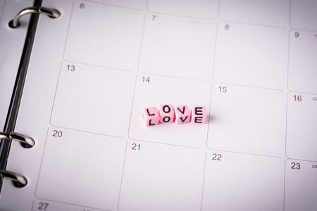 Love concept. Miniature couple against pink backgroundの写真素材