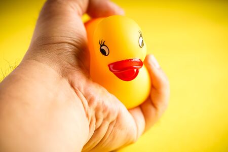 Yellow Rubber duck on yellow backgroundの写真素材