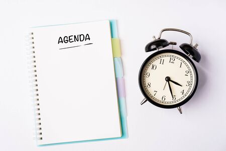 AGENDA wordings on a notebook on a table, flat lay composition, copy space for textの写真素材