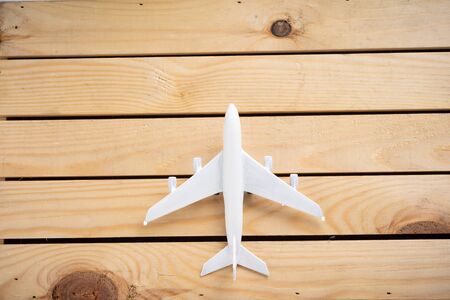 Miniature aeroplane on wooden surface with copy space for textの写真素材