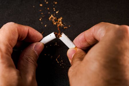 stop smoking concept, a broken cigarette isolated against black, World Tobacco Dayの写真素材