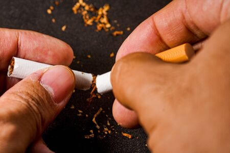 stop smoking concept, a broken cigarette isolated against black, World Tobacco Day