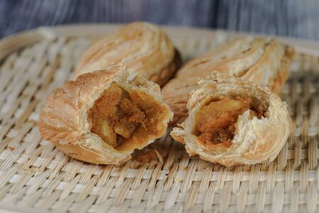 Curry puff or locally known as âKaripapâ is a Malaysian traditional food. This tasty food have flaky pastry on the outside and delicious curry potato on the insideの写真素材