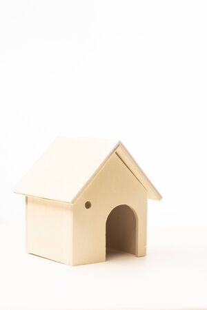 Miniature wooden house isolated against white backgroundの写真素材