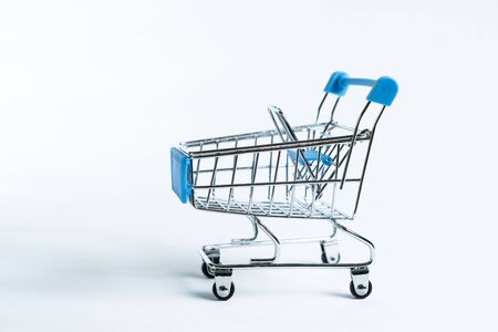 Mini shopping trolley isolated against white backgroundの写真素材