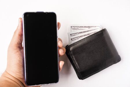 A wallet and handphone isolated on white. Concept for e-wallet or mobile wallet and cashless pay