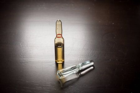 Medication ampoules for Intravenous injections on wooden background, medical conceptの写真素材