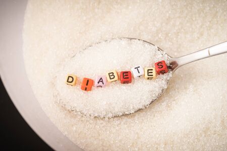 Diabetes Concept: Diabetes wordings on top of sugar heaps. November is World Diabetes Monthの写真素材