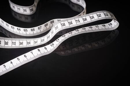 Measuring tape isolated on black