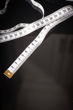 Measuring tape isolated on black