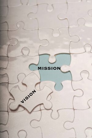 Business management concept: vision and mission wordings on puzzle piecesの写真素材