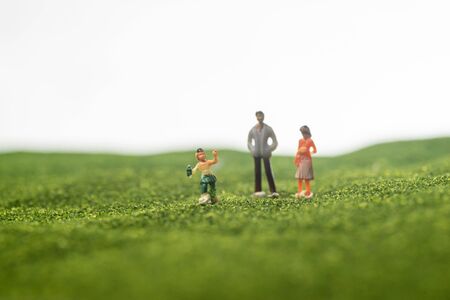Happy family concept: Miniature family figurines on a park. Selective focusingの写真素材