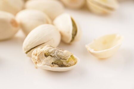Pistachio nuts isolated against whiteの写真素材