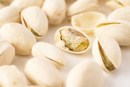 Pistachio nuts isolated against whiteの写真素材