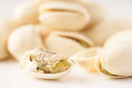 Pistachio nuts isolated against whiteの写真素材