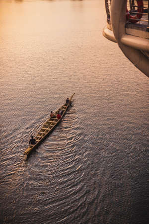 Man rowing a traditional river boat transporting people across Sarawak River. This river boat is Kuching city famous icon of sarawakのeditorial素材