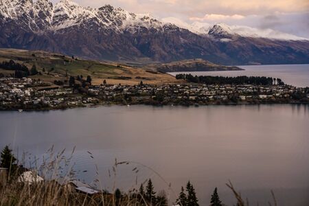 Scenic view of Queenstown, New Zealand during sunsetの写真素材
