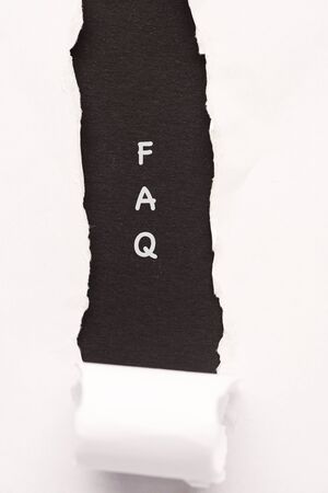 FAQ wordings on a torn paper backgroundの写真素材