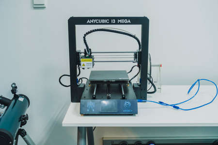 3D printer used to joined or solidified material under computer control to create a...