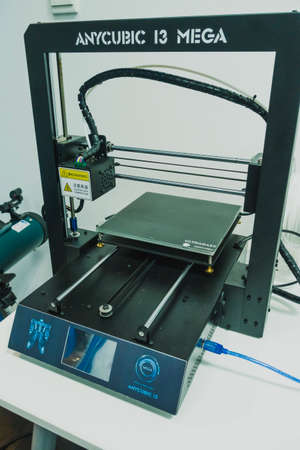 3D printer used to joined or solidified material under computer control to create a...