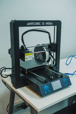 3D printer used to joined or solidified material under computer control to create a...