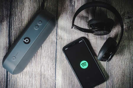 An iphone 11 screen showing spotify icon with beats earphone, perfect for listening musics on the goのeditorial素材