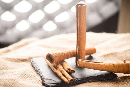 Cinnamon sticks on a black slate plateの写真素材