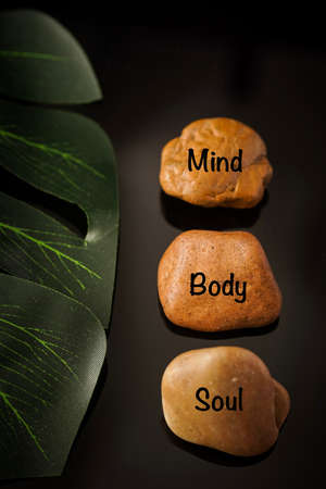 Zen Concept: Mind, Body and Soul wordings on stones against black backgroundの写真素材