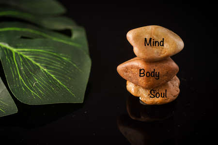Zen Concept: Mind, Body and Soul wordings on stones against black backgroundの写真素材