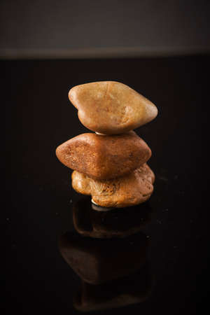 Zen concept: stones arranged against black background
