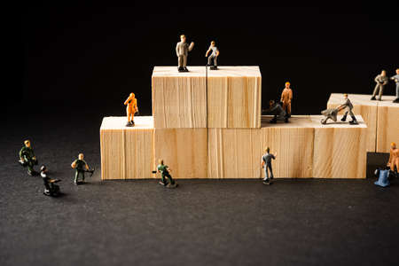 Miniature Builder Figures with wooden blocks, Labour Day Conceptの写真素材