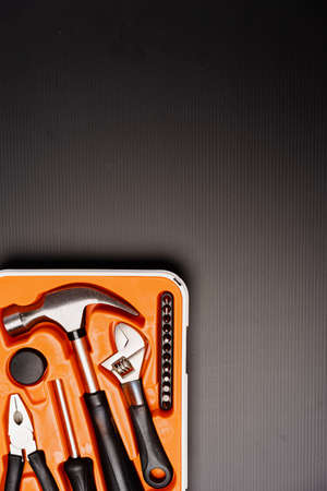 Flat lay composition of a set of tools, including hammer, pliers, wrench, screwdrivers and measuring...