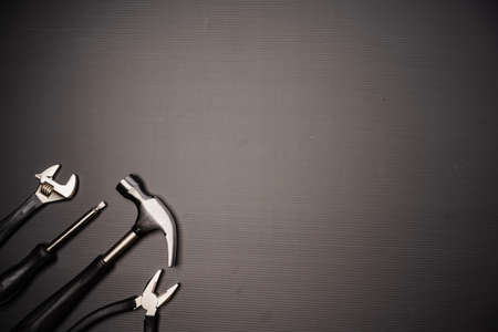 Flat lay composition of a set of tools, including hammer, pliers, wrench, screwdrivers and measuring tape. Top view, concept for fatherâs day, including copy spaceの写真素材
