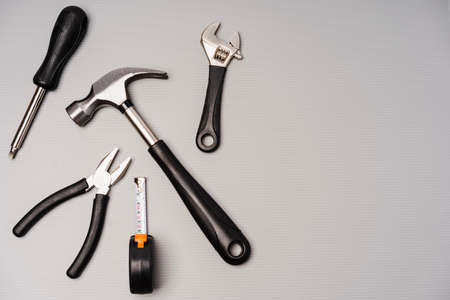 Flat lay composition of a set of tools, including hammer, pliers, wrench, screwdrivers and measuring tape. Top view, concept for fatherâs day, including copy spaceの写真素材