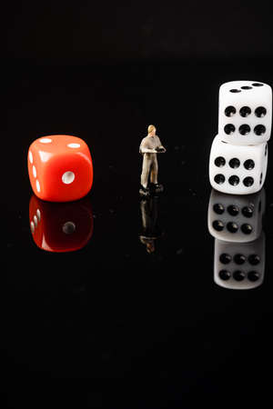 â€œRISK VS REWARDâ€ wordings with red and white dices, conceptual shot.