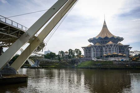 Scenic view of Kuching Waterfront showing darul hana bridge and sarawak goverment buildingのeditorial素材