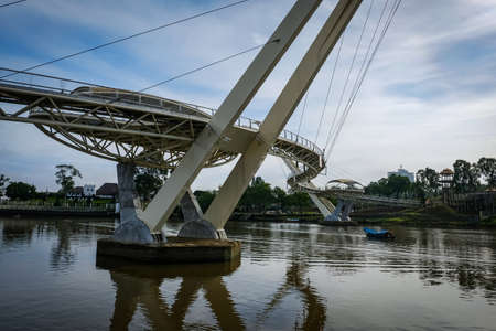 Scenic view of Kuching Waterfront showing darul hana bridge and sarawak goverment buildingのeditorial素材