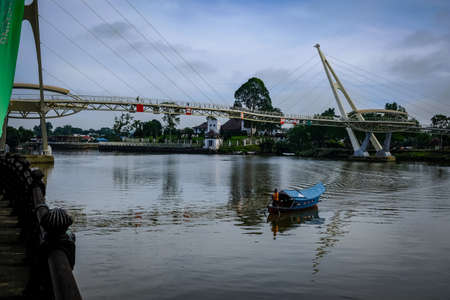 Scenic view of Kuching Waterfront showing darul hana bridge and sarawak goverment buildingのeditorial素材