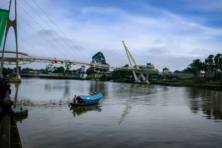 Scenic view of Kuching Waterfront showing darul hana bridge and sarawak goverment buildingのeditorial素材