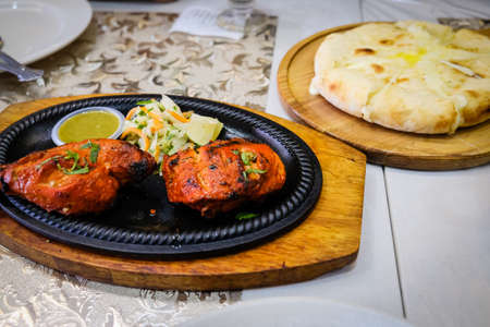 Closed up shot of a chicken tandoori on a tableの写真素材