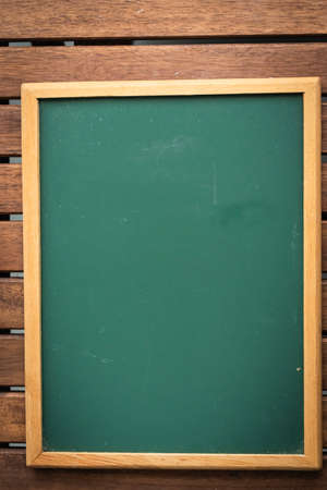 Chalkboard on a wooden table, for copyspaceの写真素材