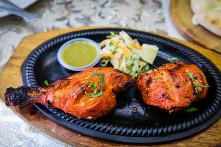 Closed up shot of a chicken tandoori on a tableの写真素材