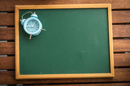 Chalkboard on a wooden table, for copyspaceの写真素材