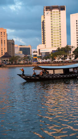 Sarawak River Cruise boat cruising along Sarawak River in Kuching Waterfront